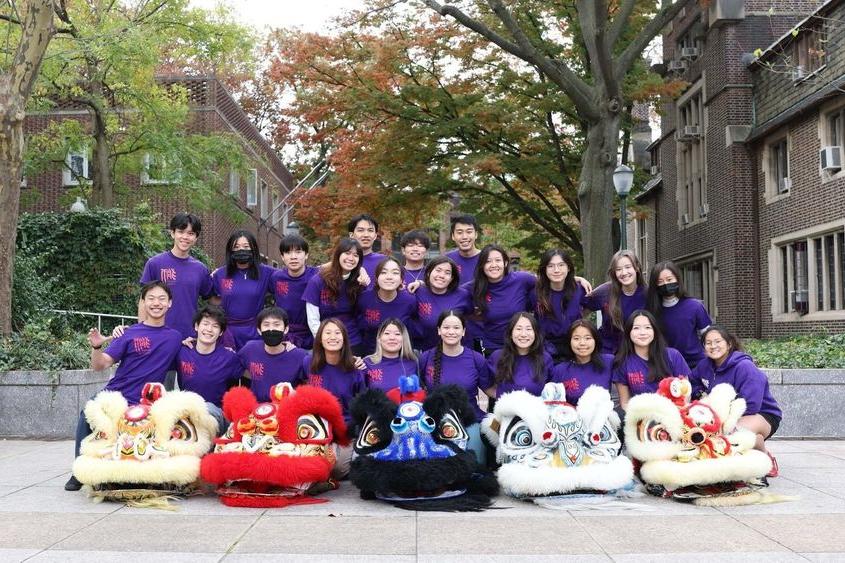 Group of students in purple shirts smiling